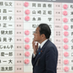 Fumio Kishida, Japan's Prime Minister and president of the Liberal Democratic Party (LDP), reacts after placing a paper rose on an LDP candidate's name, to indicate a victory in the upper house election.